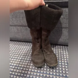 - Suede Shearling Knee High Boots in the color brown