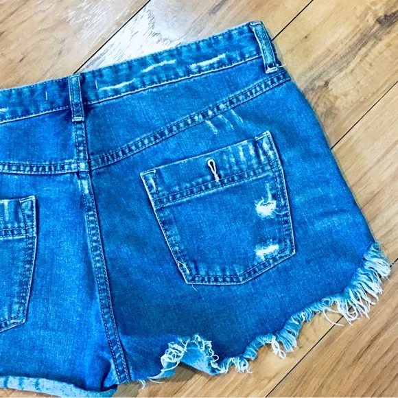 Free People denim blue jean shorts distressed cut off style 32” waist