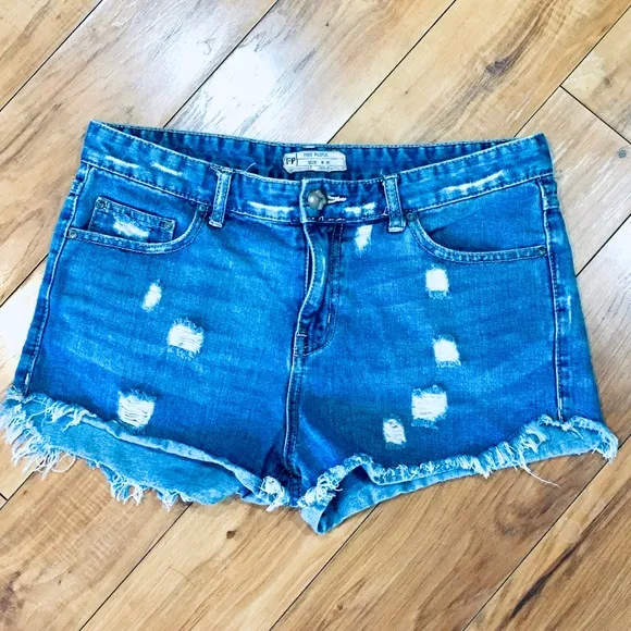 Free People denim blue jean shorts distressed cut off style 32” waist