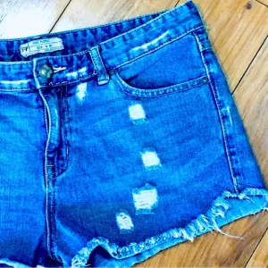 Free People denim blue jean shorts distressed cut off style 32” waist