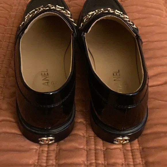 Shiny black faux leather loafers.