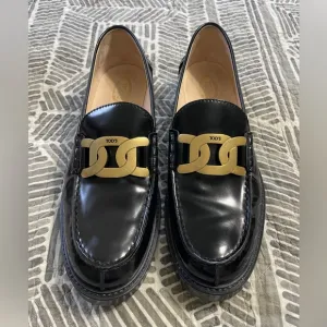 Tod's Black Leather Loafers with Gold Accent