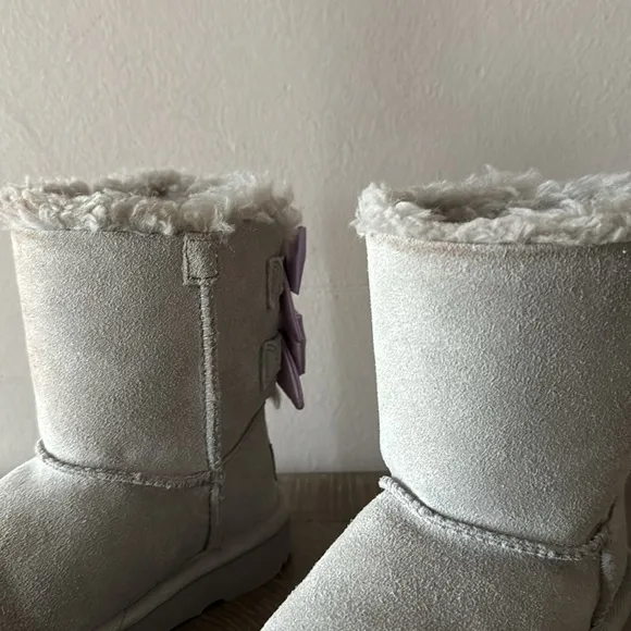 UGG gray boots with lavender bows. Little girl size 9