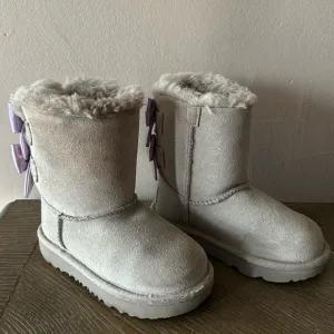 UGG gray boots with lavender bows. Little girl size 9